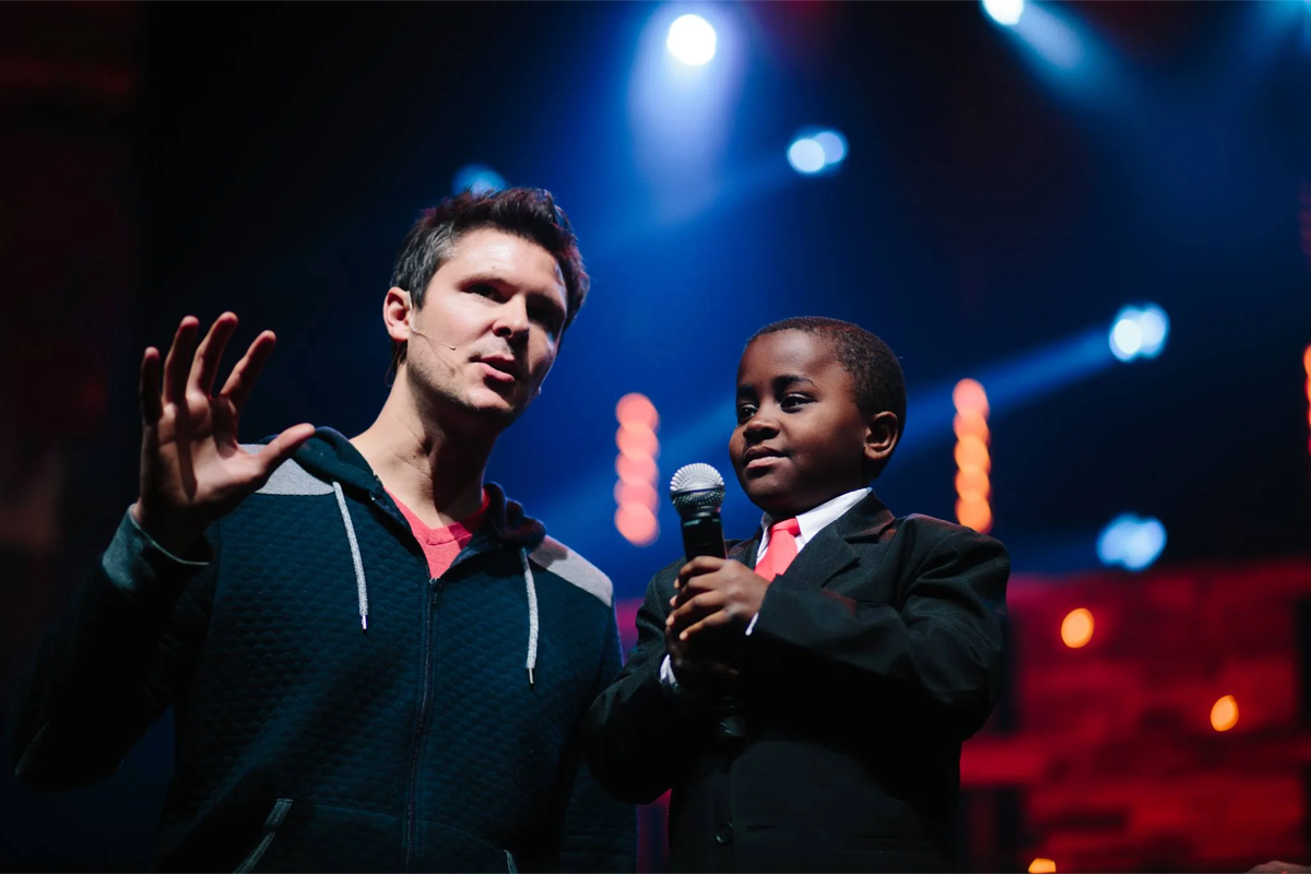 Tripp on stage with a young performer