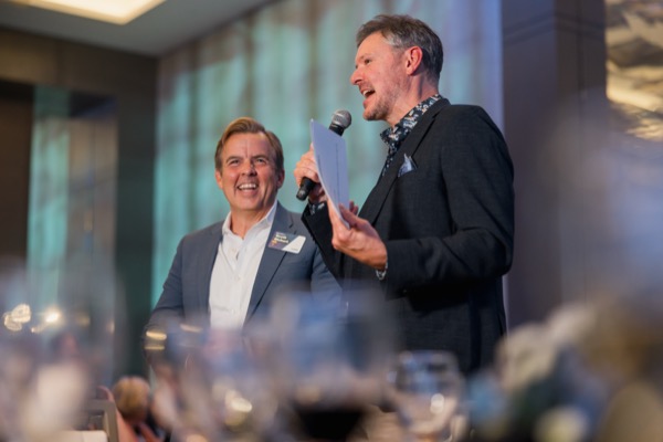 Tripp on stage with another speaker