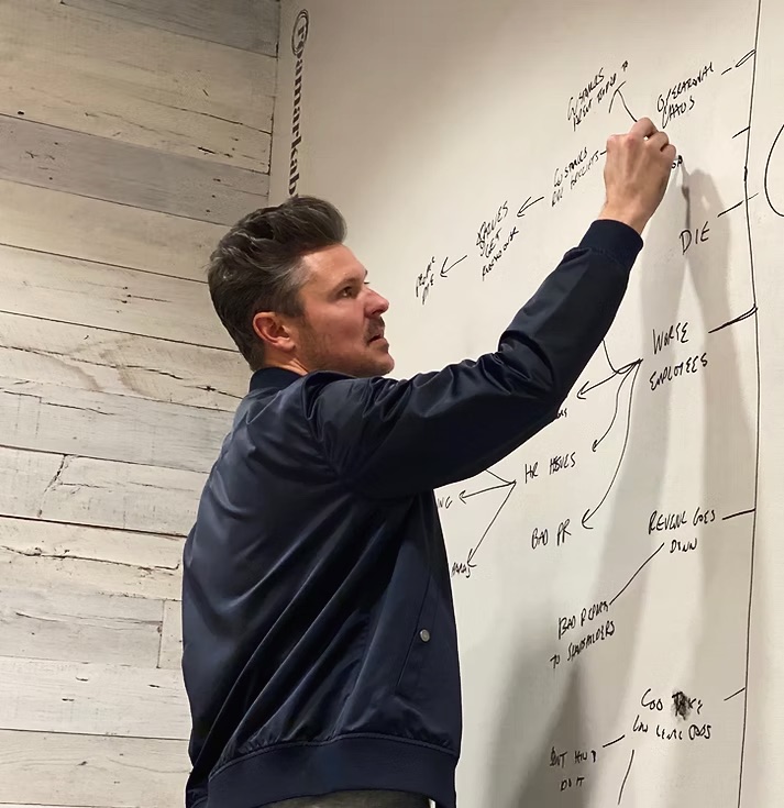 Tripp drawing on a whiteboard